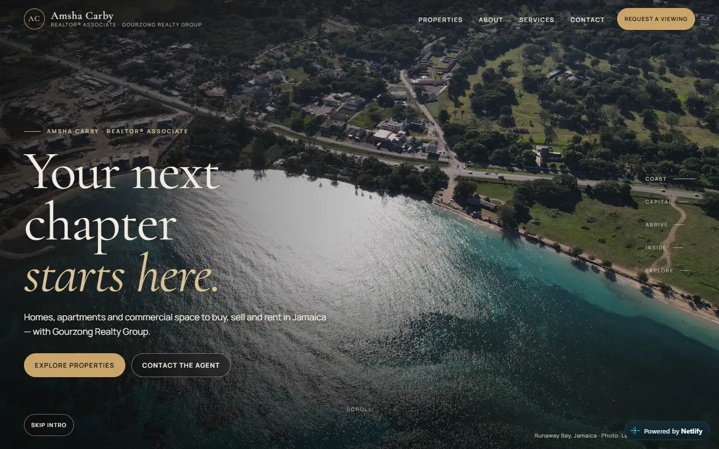 Amsha Carby homepage: “Your next chapter starts here.” over an aerial photo of the Jamaican coast